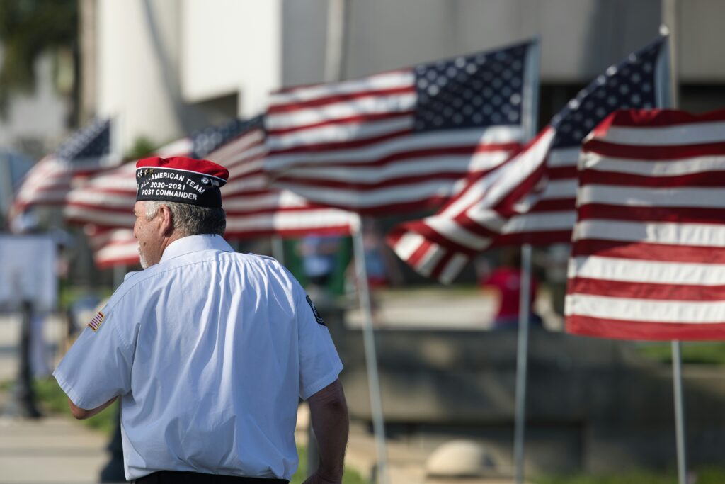 A U.S. veteran in civilian clothes watches the sunrise over his shoulder, planning the next chapter while searching for jobs for veterans in Texas.